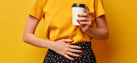 Woman With Stomach Upset With A Cup Of Coffee.